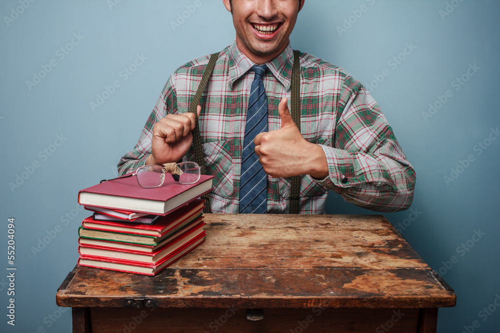 Wall mural Geek man giving thumbs up at books