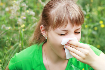 Young woman sneezing