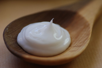 skin care cream on a wooden spoon, close up
