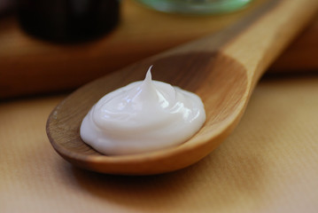 white skin care cream on wooden spoon