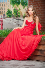 Woman in red. Beautiful young woman in red dress looking at came