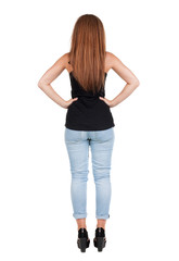 back view of standing young beautiful  redhead woman.