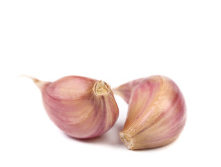 Red garlic cloves isolated on white