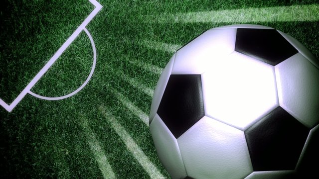 Soccer ball rotating with light rays on a soccer field