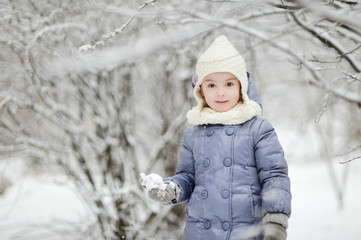 Little girl having fun on winter day