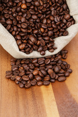 roated coffee beans spill out of the bag