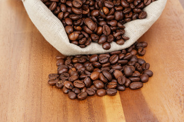 roated coffee beans spill out of the bag