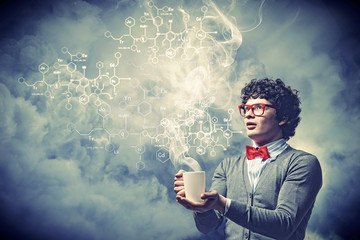 Young man with smoke coming out of cup