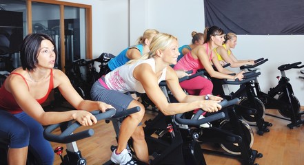 Beautiful women doing exercise in a spinning class at gym
