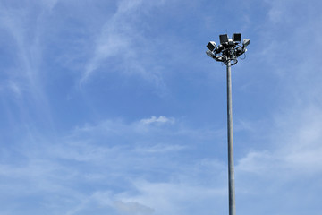 Spotlight pole isolated in blue sky