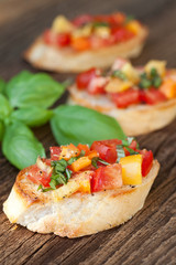 Bruschetta topped with tomato, paprika, garlic, basil