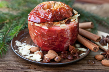 baked apple with spices and fir branch