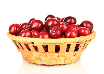 Cherry berries in wicker basket isolated on white