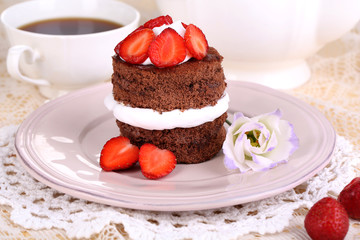 Chocolate cake with strawberry on table close-up