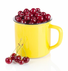 Sweet cherry in cup isolated on white