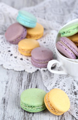 Macaroons in bowl on wooden table close-up