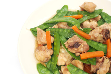 Stir fried snow peas with chicken on plate