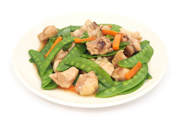 Stir fried snow peas and chicken on plate