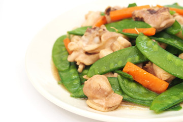 Stir fried snow peas and chicken on plate