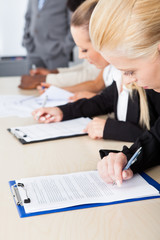 Business executives taking notes during a meeting