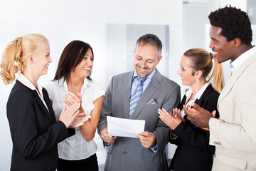 Happy Businesspeople Applauding Businessman