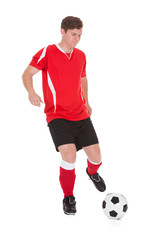 Fototapeta na wymiar Soccer Player Kicking Ball
