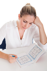 Young Woman Solving Sudoku