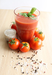 tomato juice in a glass on a wooden surface