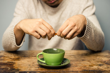 Man sweetening his drink
