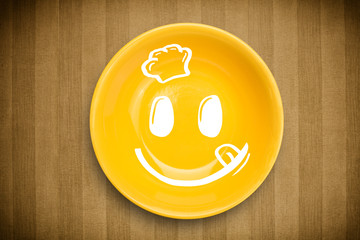 Happy smiley cartoon face on colorful dish plate