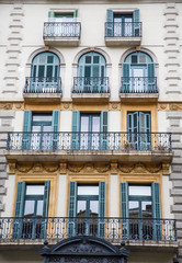 Obraz premium Green Shutters and Black Wrought Iron Balconies