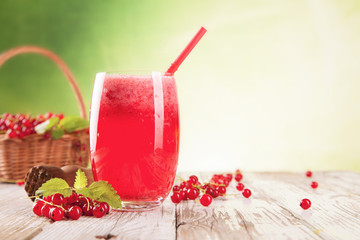 Fresh currant drink on wood