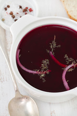 beet soup in white bowl with spoon