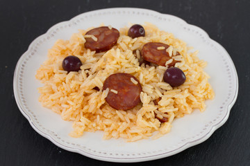 sausages with rice on the white plate
