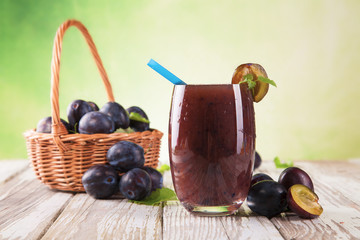 Fresh plum drink on wood