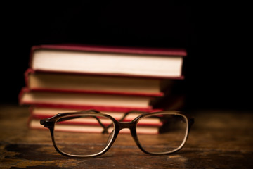 Stack of books with a pair of glasses