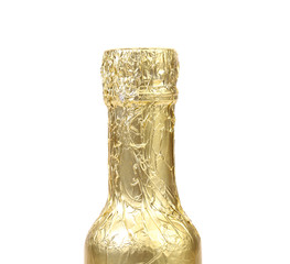 Bottle neck wrapped with gold foil.