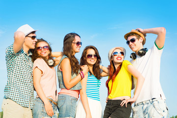 group of young people wearing sunglasses and hat