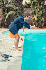 Funny Young Businessman with SwimmingTrunks Diving  into the Poo