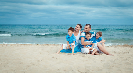 Fototapeta na wymiar Young family with three kids on vacation