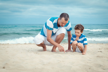 Fototapeta na wymiar Father and son sitting on sea