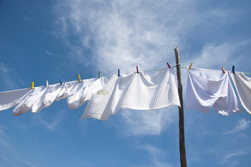 Laundry drying on the rope outside - obrazy, fototapety, plakaty