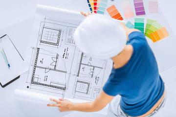 woman with color samples and blueprint