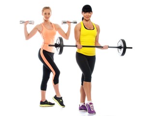 Fototapeta na wymiar Two beautiful sporty girls doing fitness exercises