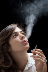 Woman Smoking a Cigarette on Black Background