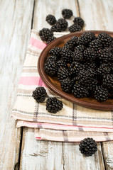 Fototapeta na wymiar ripe blackberries in a clay bowl