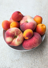Fresh summer apricots and peaches in a bowl