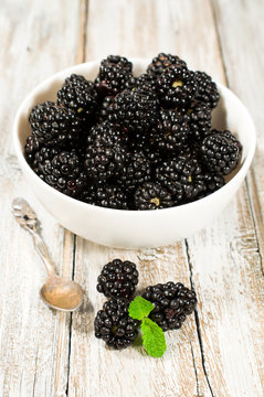 ripe blackberries on wooden background