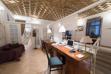 A small room with two desks and a door