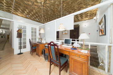 A small room with two desks and a door